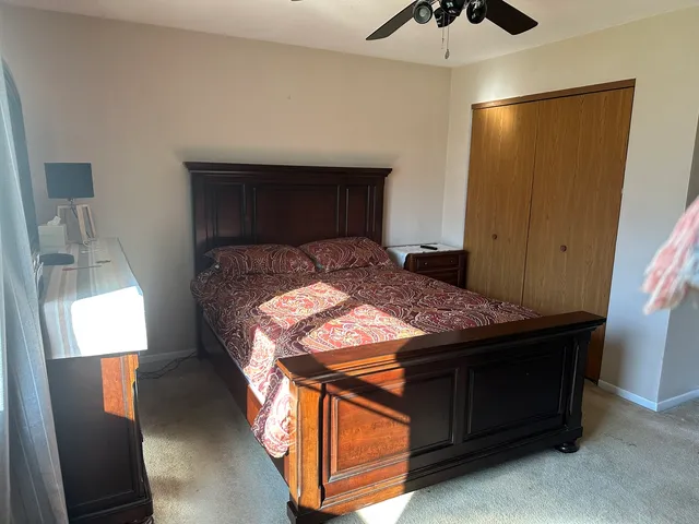 a bed sitting in a bedroom next to a window