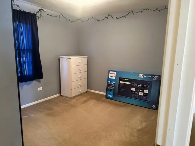 a view of an empty room with furniture and a fireplace