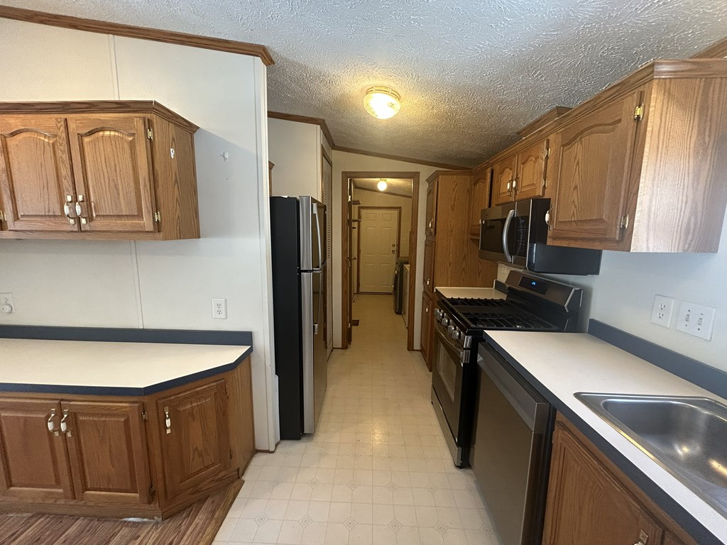 321 Ridge Avenue Avenue Strattanville, PA 16258 - Photo 9 of 29 a kitchen with a sink dishwasher stove and refrigerator