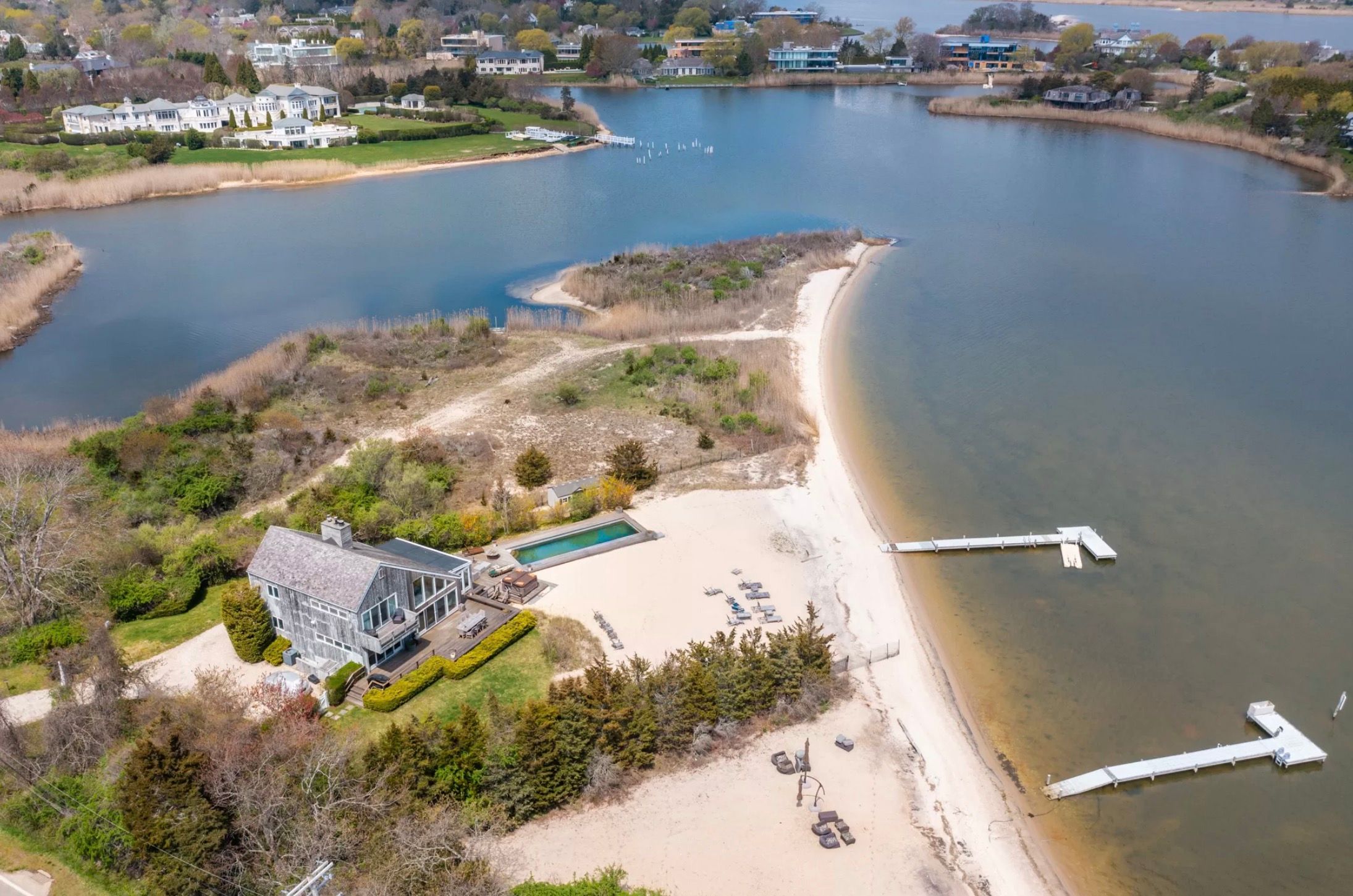 an aerial view of a house with a lake