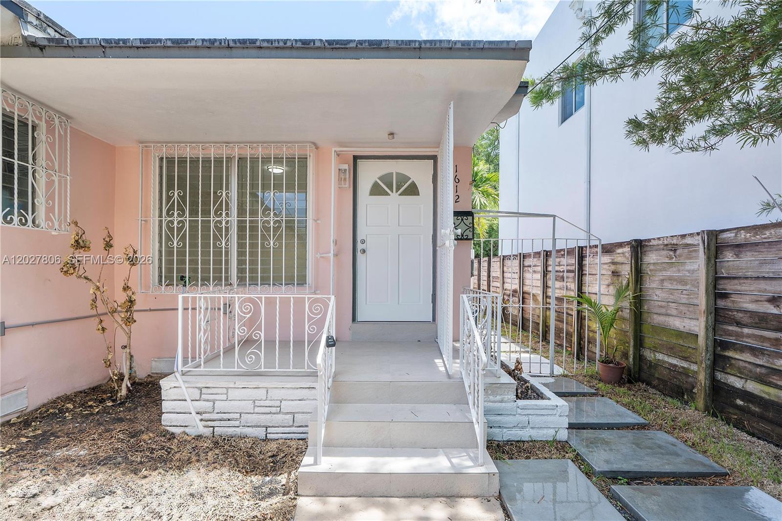 1612 Southwest 23rd Street, Unit 1612 Miami, FL 33145 - Photo 2 of 42 a front view of a house with a porch