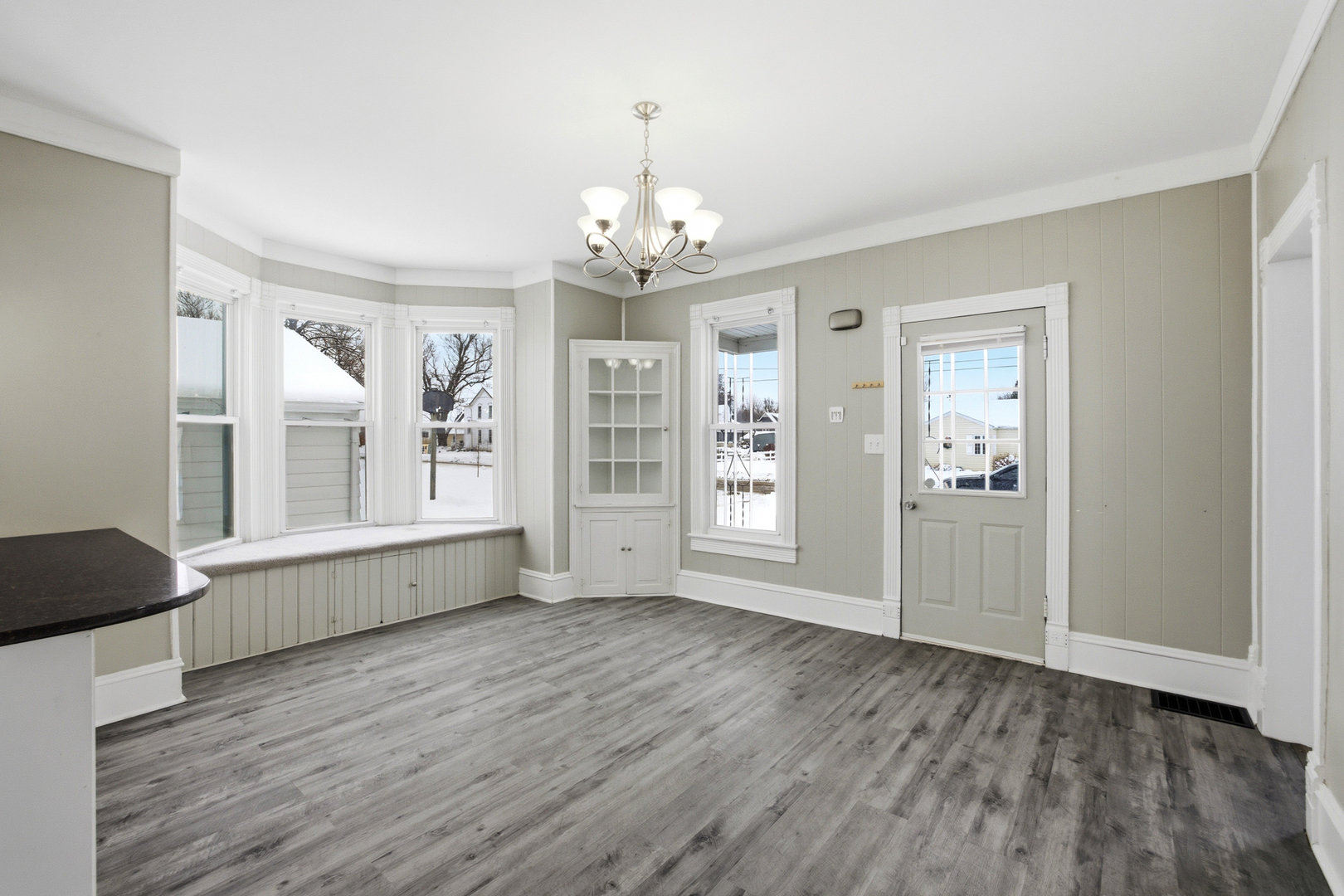 406 West Balsam Street Forreston, IL 61030 - Photo 11 of 36 a view of an empty room with wooden floor and a window