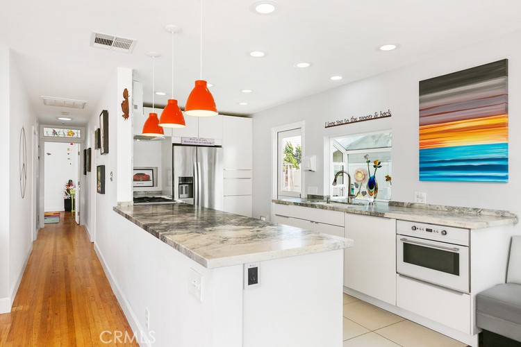 24272 Selva Road Dana Point, CA 92629 - Photo 17 of 39 a very nice looking kitchen with granite countertop a stove and a sink