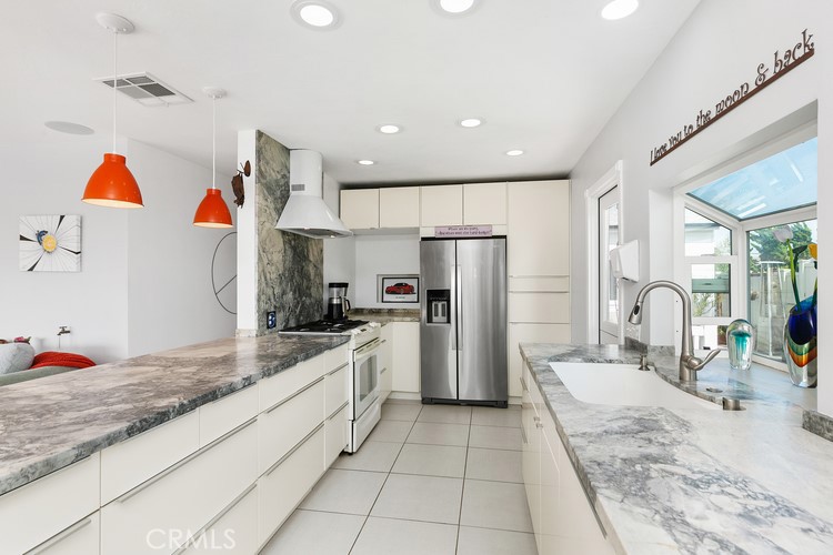 24272 Selva Road Dana Point, CA 92629 - Photo 18 of 39 a kitchen with stainless steel appliances kitchen island granite countertop a refrigerator and a sink