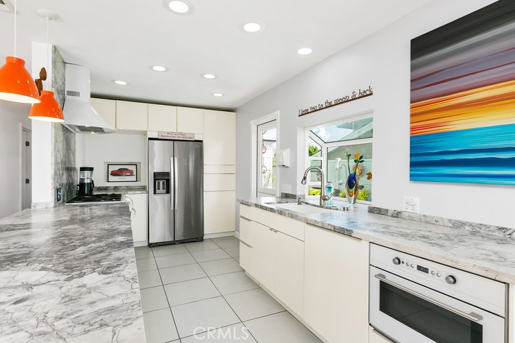 24272 Selva Road Dana Point, CA 92629 - Photo 20 of 39 a kitchen with stainless steel appliances granite countertop a refrigerator and a sink