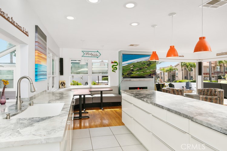 24272 Selva Road Dana Point, CA 92629 - Photo 22 of 39 a kitchen with stainless steel appliances kitchen island granite countertop a sink and cabinets