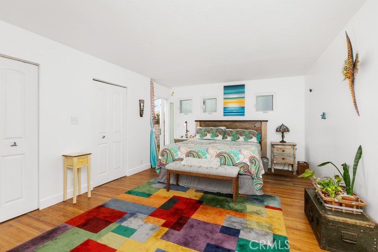 24272 Selva Road Dana Point, CA 92629 - Photo 24 of 39 a bedroom with furniture and a wooden floor