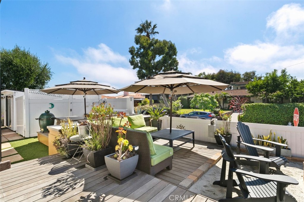 24272 Selva Road Dana Point, CA 92629 - Photo 31 of 39 a view of a chairs and table in the backyard