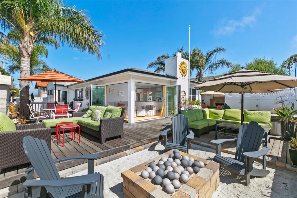 24272 Selva Road Dana Point, CA 92629 - Photo 4 of 39 a patio with a table and chairs under an umbrella