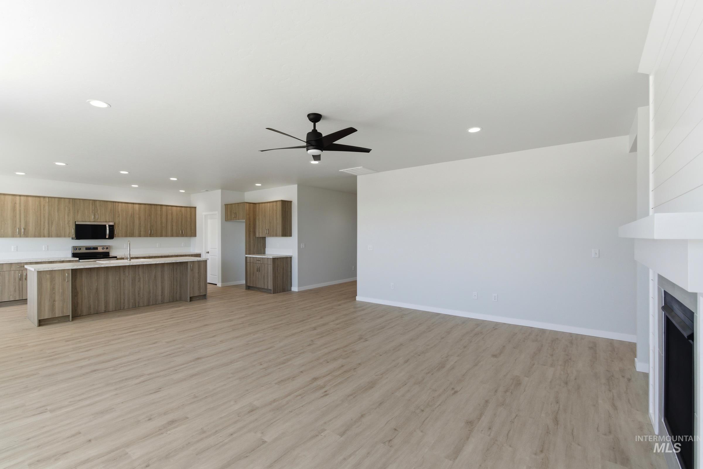 13663 Redway Court Caldwell, ID 83607 - Photo 13 of 32 Open-concept living space featuring wood-finish flooring, recessed lighting, and a contemporary ceiling fan