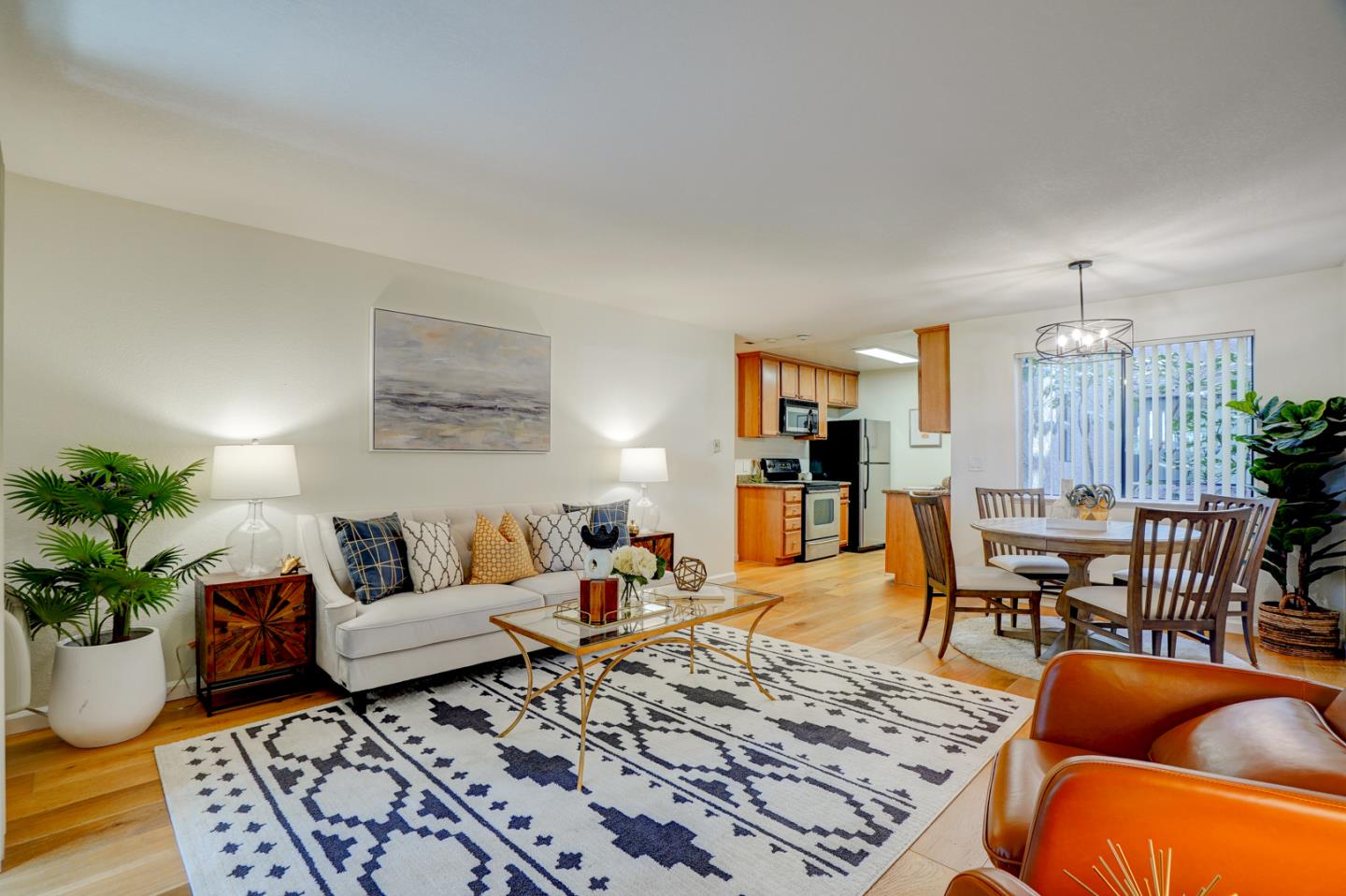 a living room with furniture a rug and a table