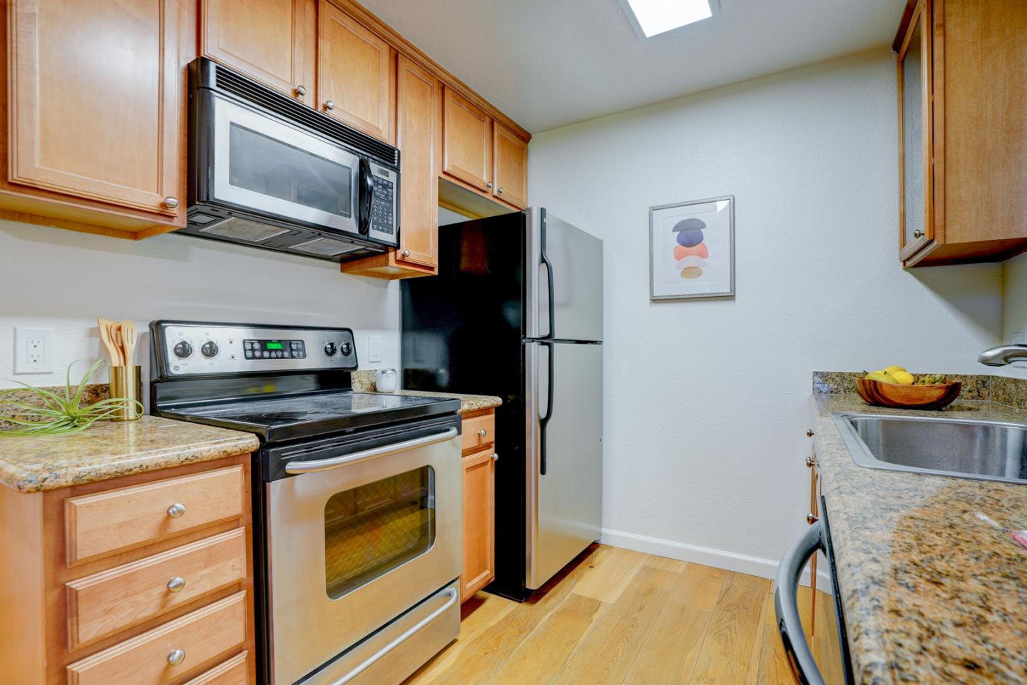 2250 Monroe Street, Unit 192 Santa Clara, CA 95050 - Photo 18 of 33 a kitchen with stainless steel appliances granite countertop a stove and a microwave