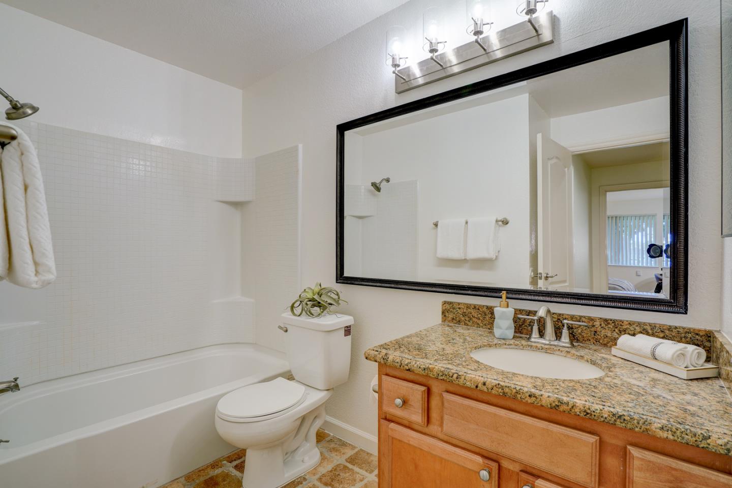 2250 Monroe Street, Unit 192 Santa Clara, CA 95050 - Photo 25 of 33 a bathroom with a granite countertop sink mirror vanity and toilet
