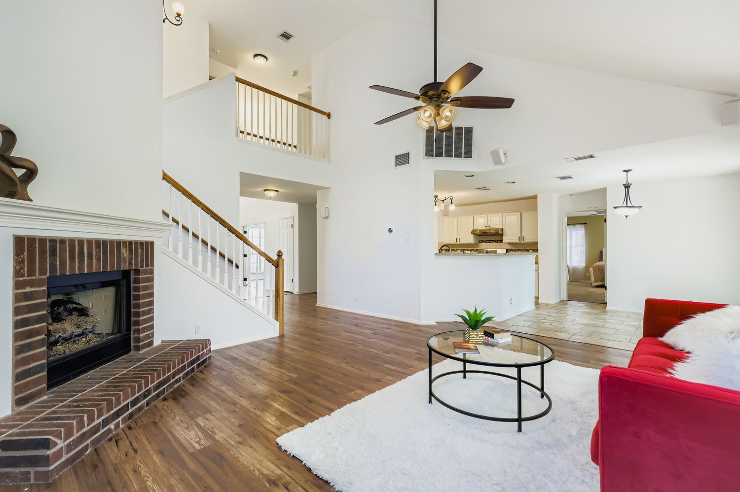 1126 Red Ranch Circle Cedar Park, TX 78613 - Photo 1 of 1 Living area featuring wood finished floors, a fireplace, high vaulted ceiling, a ceiling fan, and stairway