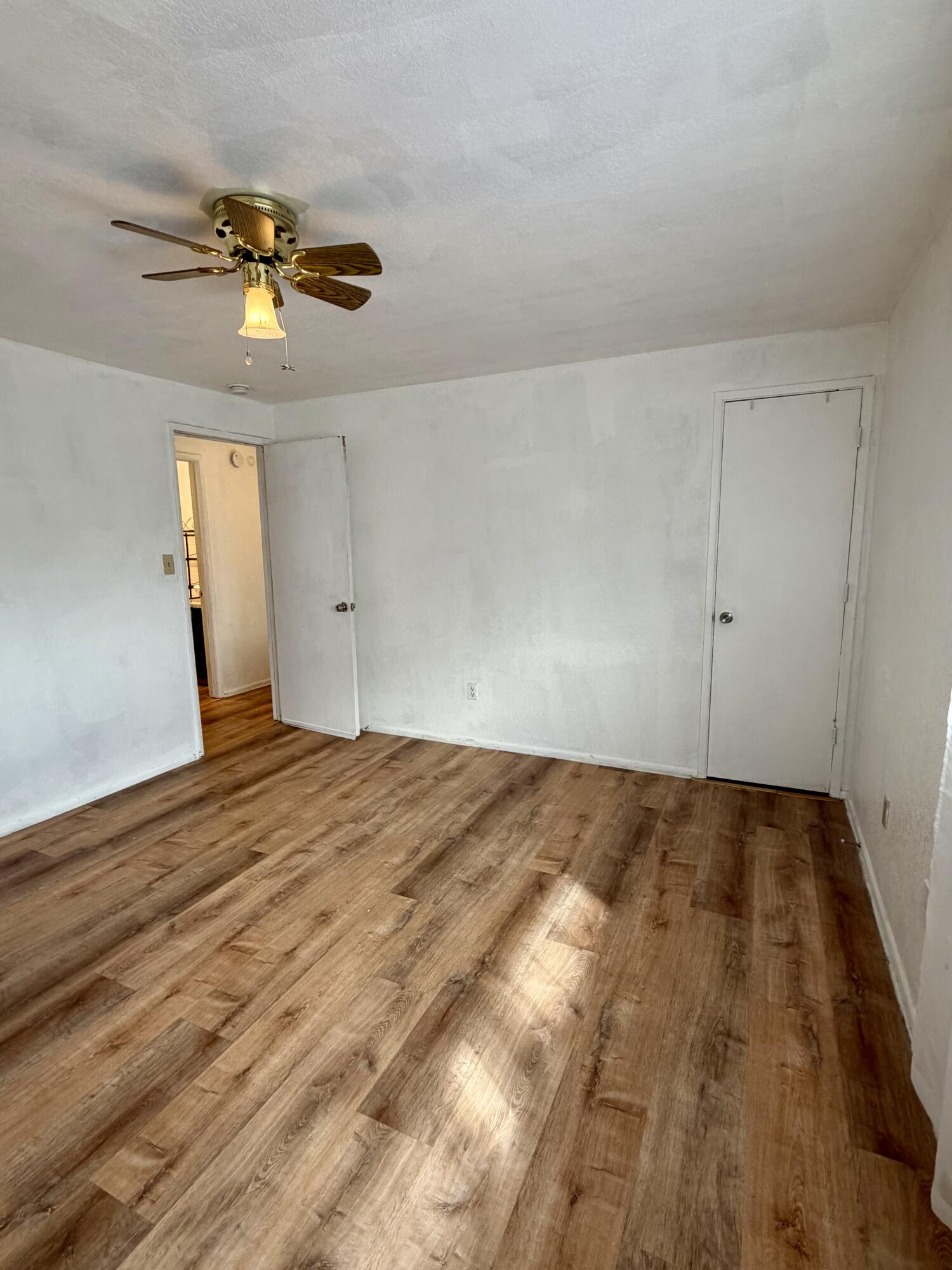 1198 Morrow Road, Unit A Medford, OR 97504 - Photo 17 of 20 a view of a livingroom with a chandelier fan and wooden floor