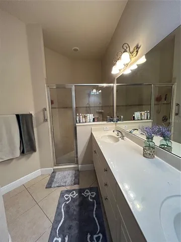 a room with a sink a mirror and washer dryer