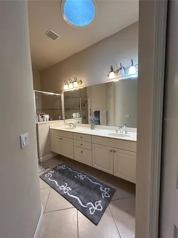 a room with a sink mirror and vanity