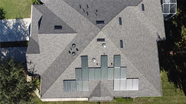 an aerial view of a house with a yard