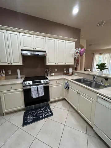 a kitchen with a sink cabinets and appliances