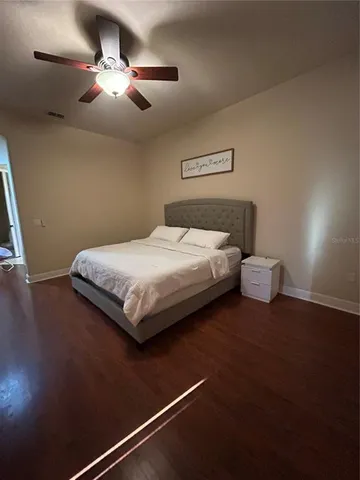 a bedroom with a bed and a chandelier