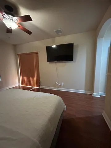a bedroom with a bed and a flat screen tv