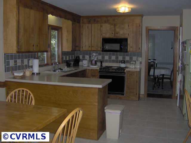 2612 Olde Stone Road Midlothian, VA 23113 - Photo 3 of 10 a kitchen with stainless steel appliances granite countertop a stove a sink and a microwave