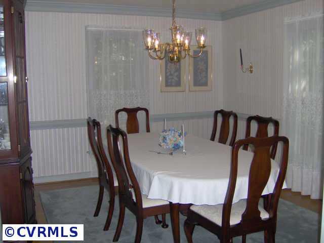 2612 Olde Stone Road Midlothian, VA 23113 - Photo 4 of 10 a view of a dining room with furniture and chandelier