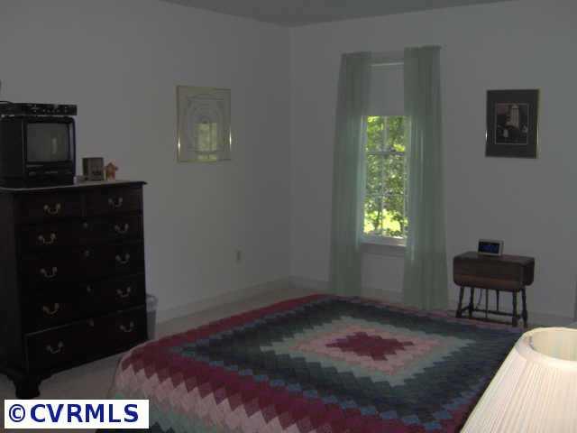 2612 Olde Stone Road Midlothian, VA 23113 - Photo 6 of 10 a bedroom with a bed and a window