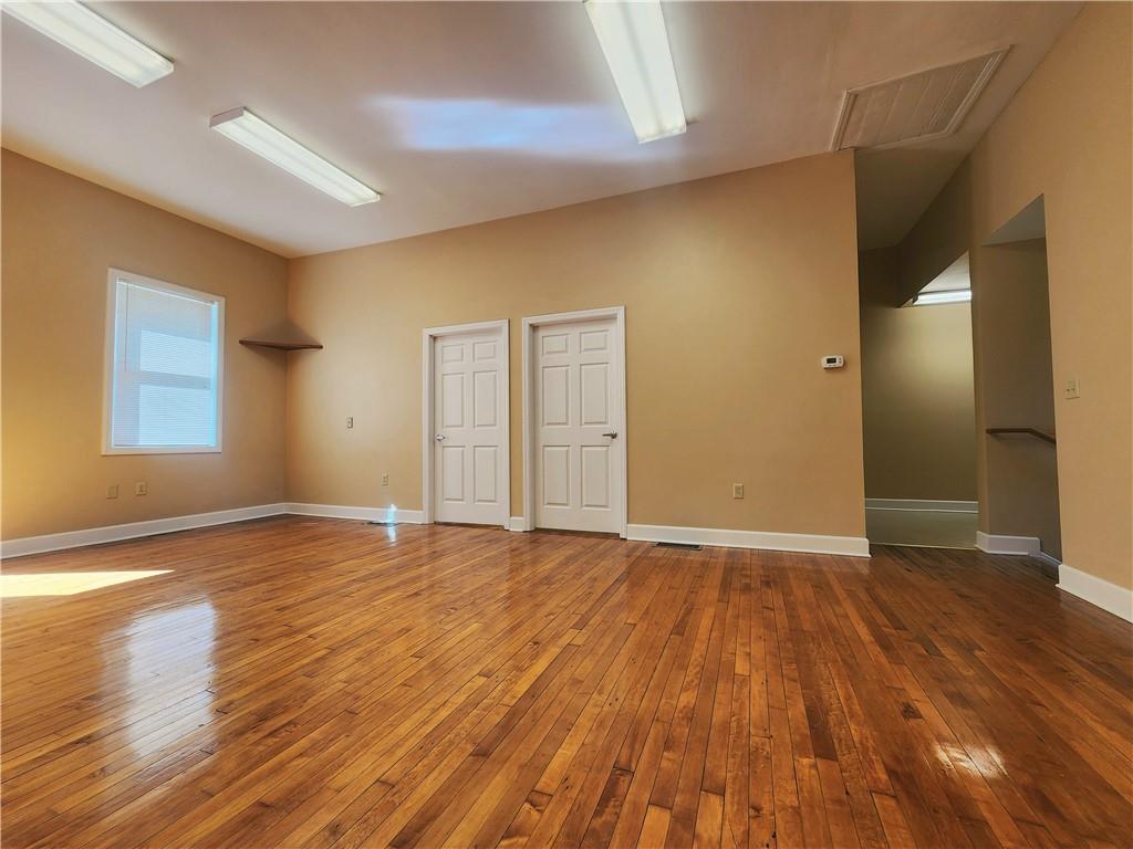1750 Harbor Edinburg Road Edinburg, PA 16116 - Photo 12 of 39 a view of an empty room with wooden floor and a window