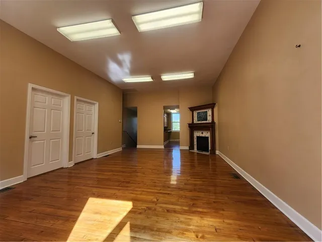 a kitchen with wooden floors and a sink