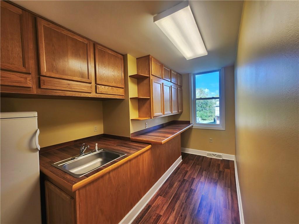 1750 Harbor Edinburg Road Edinburg, PA 16116 - Photo 14 of 39 a kitchen with wooden floors and a sink