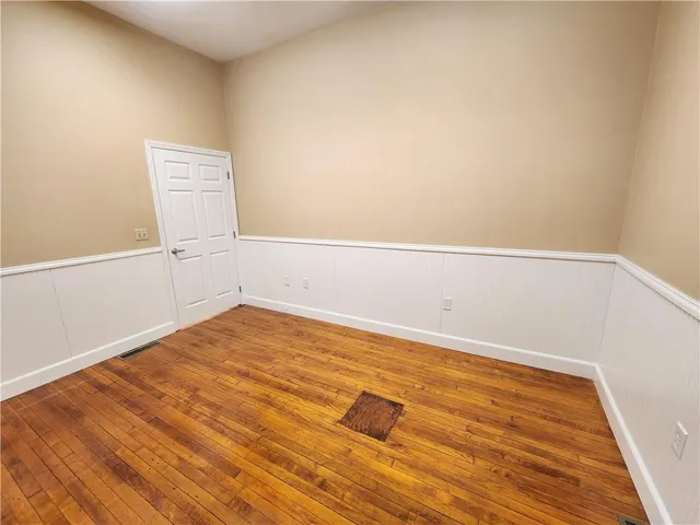a view of a room with wooden floor and white doors