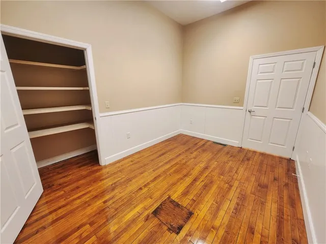 a room with wooden floor and a window