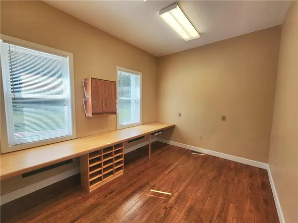a view of a room with wooden floor and cabinet