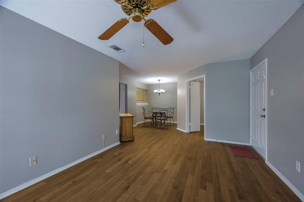 18333 Roehampton Drive, Unit 1412 Dallas, TX 75252 - Photo 4 of 14 a view of empty room with wooden floor