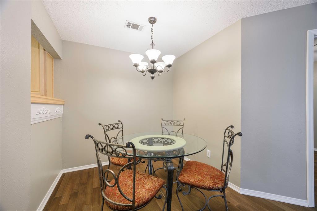 18333 Roehampton Drive, Unit 1412 Dallas, TX 75252 - Photo 5 of 14 a view of a dining room with furniture and wooden floor