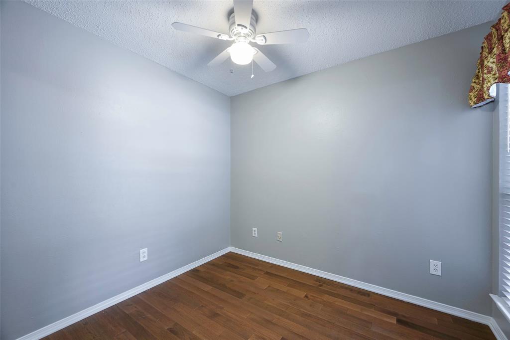 18333 Roehampton Drive, Unit 1412 Dallas, TX 75252 - Photo 6 of 14 a view of an empty room with wooden floor