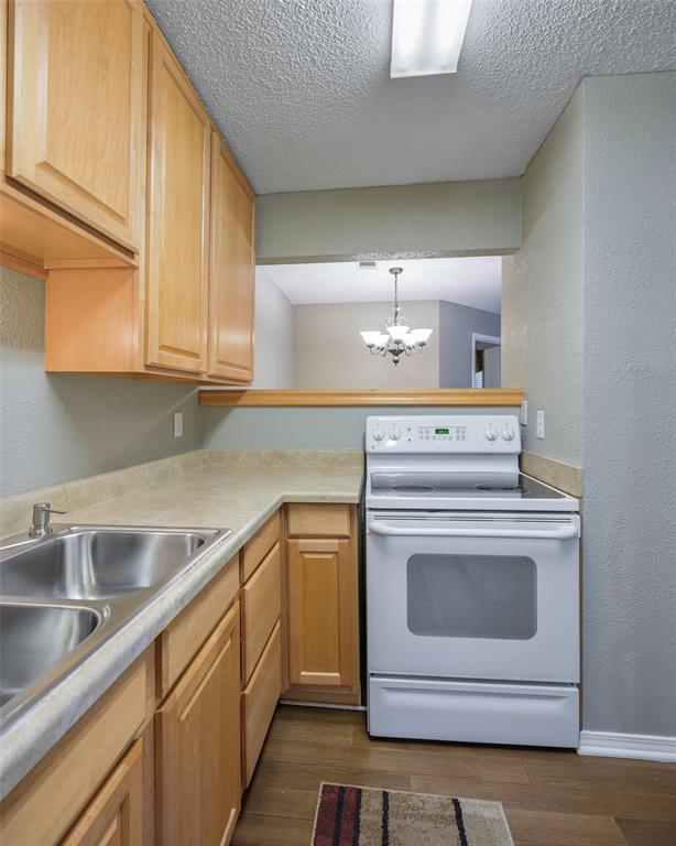 18333 Roehampton Drive, Unit 1412 Dallas, TX 75252 - Photo 10 of 14 a kitchen with a sink stove and cabinets