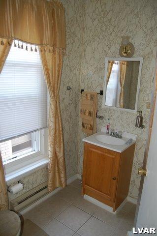 128 South 12th Street Allentown, PA 18102 - Photo 11 of 19 a bathroom with a sink and a mirror