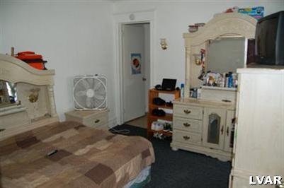 128 South 12th Street Allentown, PA 18102 - Photo 13 of 19 a bedroom with a bed and wooden floor