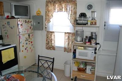 128 South 12th Street Allentown, PA 18102 - Photo 15 of 19 a living room with fireplace furniture and a flat screen tv