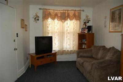128 South 12th Street Allentown, PA 18102 - Photo 2 of 19 a living room with furniture and a flat screen tv