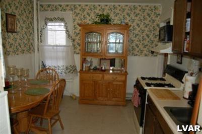 128 South 12th Street Allentown, PA 18102 - Photo 3 of 19 a dining room with furniture and a kitchen view