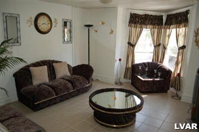 128 South 12th Street Allentown, PA 18102 - Photo 7 of 19 a living room with furniture and a large window