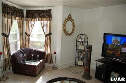 128 South 12th Street Allentown, PA 18102 - Photo 8 of 19 a living room with furniture a window and a flat screen tv