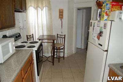 128 South 12th Street Allentown, PA 18102 - Photo 9 of 19 a kitchen with stainless steel appliances a stove a sink and a refrigerator