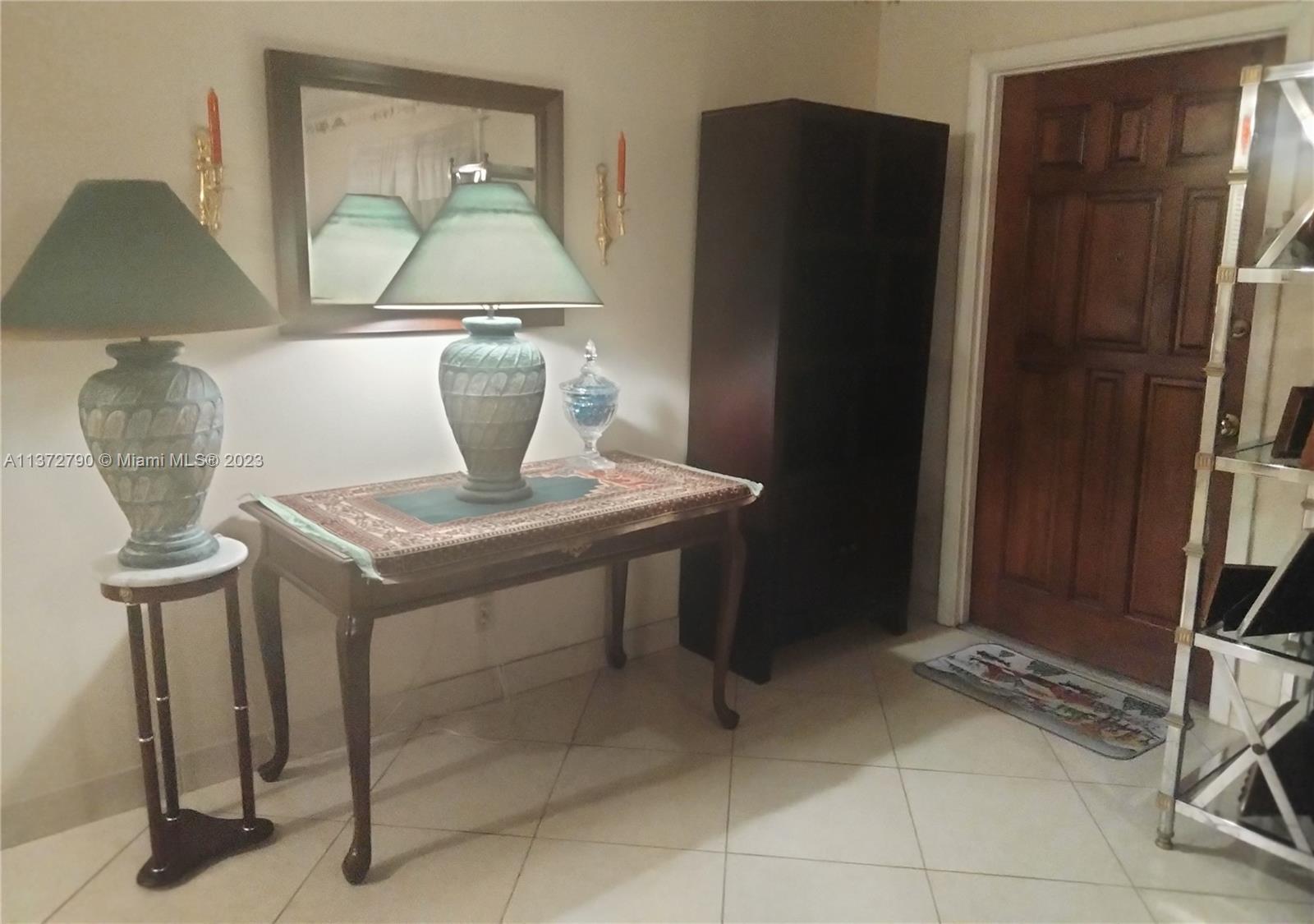 Paradise Gardens Margate, FL 33063 - Photo 4 of 12 a kitchen with a table and a refrigerator