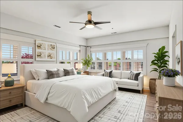 a bedroom with a large bed and a couch