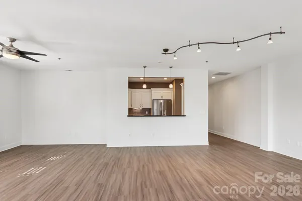 a view of a room with wooden floor