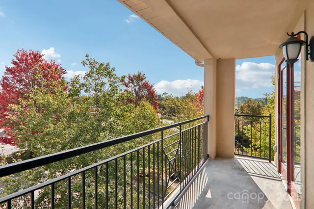 a view of a balcony with wooden floor